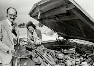 Alternative fuel: Pat DiFonzo, left, president of Alternative Fuel Systems Ltd., and employee Gian Luigi Turci show parts used to convert car from gasoline to propane.