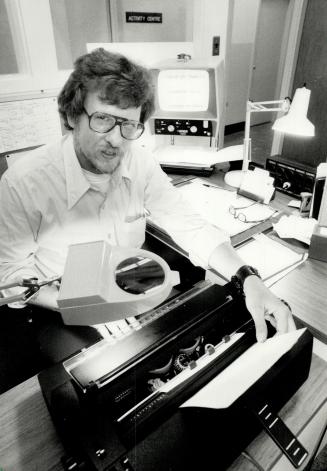 New receptionist: Sitting at his typewriter is Bill Dimberline, a visually impaired CNIB client.