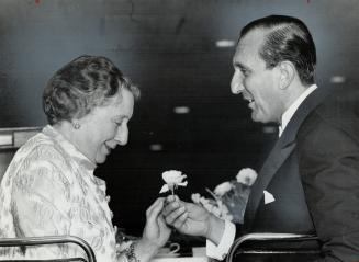 Opera Guild holds dinner, The Italian Ambassador, His Excellency Allesandro Frace di Villaforesta, offers a rose to Vida Peene, chairman of the Canadian Opera Guild, at the groups's eighth annual dinner Saturday night. It was held at O'Keefe Centre.