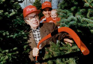 Generations growing evergreen, Howard R Drysdale, grandson Douglas Jr., great-granddaughter Serena, 6 months, represent three of four generations serving local Christmas tree buyers.