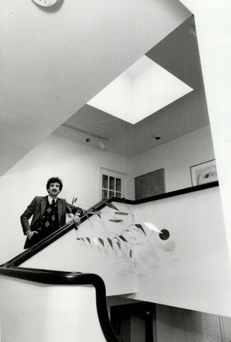 Open and light: Architect Jackson Eidelberg, above, shows off open staircase and lightwell he designed in a client's home to give feeling of space.