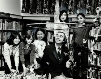 Making a wish: Regent Park students, from left, Jeanette Espiritu, Kathleen Culien, Sinmin So, Ruby Nayyar and Un-Mi Lee, surround principal Chris Dorevich with paper cranes in the hope that their wish will come true and he won't be transferred after all.