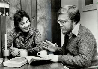 Examining their faith: Teacher Mary Duffy relaxes at home with her husband, Dennis, a U of T professor.