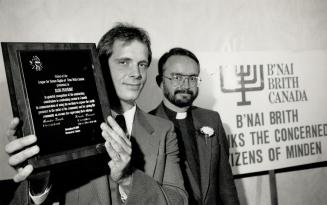 Good Fight: Russ Duhaime, left, holds the plaque that he and Rev. Edward Moll received from B'Nai Brith Canada yesterday in recognition of their campaign against bigotry.