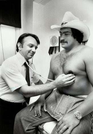 You gotta have heart, Argos' team physician Dr. Robert Dzioba examines offensive lineman Bill Norton yesterday at Toronto Western Hospital. The Argos underwent physicals yesteday and will begin training today at the University of Guelph.