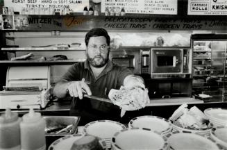 Rye Guy: Co-owner Paul Dulberg serves up one of Switzer's famous overstuffed sandwiches on the dell's last day at its Spadina Ave. address.