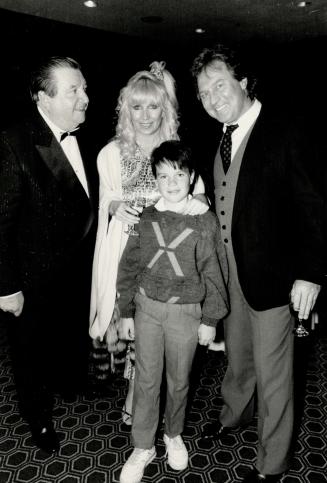 Left, William M. Dunne, president of the Ontario Food Brokers Association and chairman of Gala '88, greets Las Vegas singer Glenn Smith, his wife Linda and son Jason, 9.