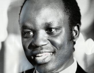 Foreign Minister, Paul Etiang of Uganda talks with newsmen at a reception he gave last night in his Ottawa hotel. Earlier in the day, Etiang read a 55-minute speech written by President Idi Amin blaming Britain for many African problems and charging the Commonwealth is a talk shop.