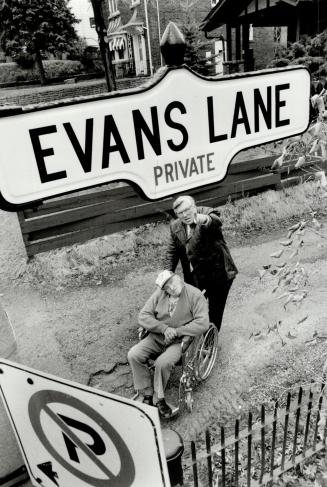 In his honor: Donald Evans pushes his wheelchair-bound father Ed to the site of a lane named in his honor last week.