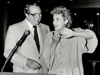 David Evans with Anne Murray, who wore trousers, a long vest and jacket, all in aqua suede with white jazz oxfords.