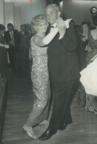Gordon Gibson, Vancouver lumber-millionaire who flew from Honolulu for the party, is shown dancing with Mrs. Russ Baker, widow of the famous bush pilot.