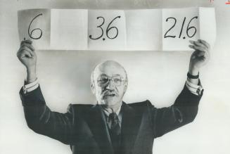 Holding a sign, which he displayed to shareholders at the annual meeting of the Unity Bank of Canada, yesteday, is Alexander Gerol, who seeks to organize dissident shareholders. The first two figures refer to Unity's losses in 1975 and 1976 in millions a