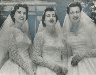 Three pretty daughters of the ambassador of Peru, German Fernandez-Concha, took their wedding vows in a triple ceremony at St. George's Roman Catholic church in Ottawa Saturday. Shown here in their gowns, which are identical, are, from left, Amparo, 20, V