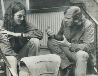 The youth culture is overserviced, says John Fisher, right, who heads a co-ordinating body for Toronto youth services. Fisher, talking to student Roger Ames, says the youths who didn't need the services badly probably became sick as a result of this depen