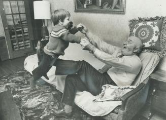 Retired Metro police superintendent John Gillespie, realxing with his grandson, Christopher Orr, above, says in letter that police officers of even citizens are not adequately protected under one-man patrol system. It is acceptable only by daylight, he sa