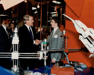 Prime Minister Brian Mulroney meets Michael Gerstweiler, a Gold Medal winner at the National Conference on Technology and Innovation at the Sheraton Centre last week. Gerstwiler won the award for his work on robots.