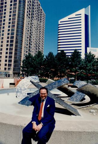 Price projects: David Feldman, president of Camrost Developments Corp., sits near his two newest structures - the silver-colored Madison Centre office tower (right) and a condominium project, Residences of Madison Centre.