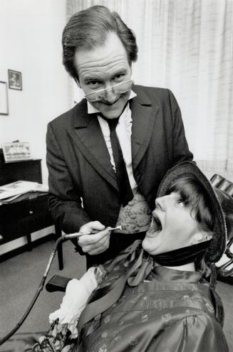 Dr. Peter Fendrich demonstrates old-style dental techniques on Corinne Kovalsky.