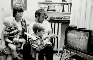 Not impressed: Robert Fothergill sees nothing of benefit for his family as he, his wife Eleanor Dudar and their sons Patrick, 7, and Simon, 3, watch details of the new budget unfold last night. As a whole, the budget contained too much for business and to