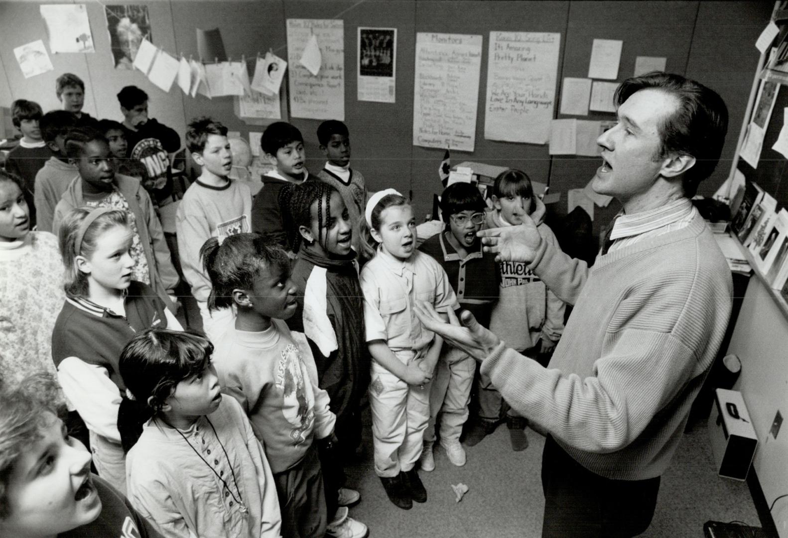 Larry Folk, a Metro music teacher reassigned to a regular class, leads a lunch-hour choir practice at St. Thomas More school.
