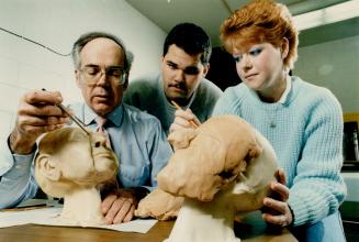 Don Foster, left, head of funeral directors course at Humber College, shows Yves Gauthier, 23, and Jacqueline Paterson, 18, facial reconstruction on a model