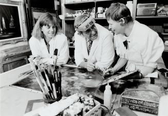 Rescue mission: Master artisan George Franciscy and his wife, Hanna, right, work, with former art teacher Krisztina Meuring on restoring a European still life painted around 1909