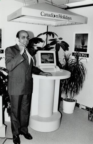 Hi-tech shopping: Company president Errol Francis shows off what Canadian Holidays bills as the world's first computerized travel brochure