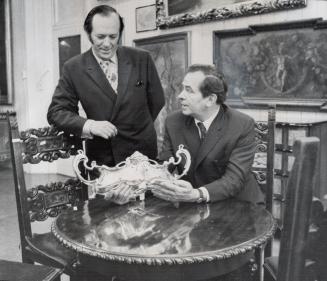Art Nouveau silver flower bowl is examined by Frank Frankfurter (left) owner of the World of Antiques on King St