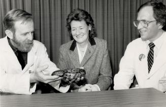 Research breakthrough: Dr. Michael Glynn holds a dead water moccasin, a pit viper closely related to the snake whose venom was used to help save a man's life during a heart operation. Doctors Sally Teasdale and Vytas Zulys, also part of the hospital team,