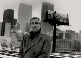 Sign of success: Peter Gallop stands in front of one of unipole billboards erected by Gallop and Gallop in the Jarvis St