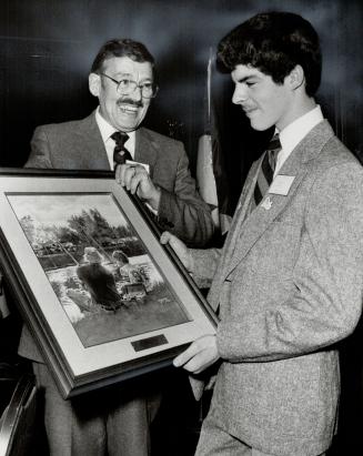 Mr. Big: Harry Gardiner of Hallifax, chosen Canada's Big Brother of the year last night at the Hyatt Regency Hotel, holds a painting awarded to him as his Little Brother, Kelvin Dion, 15, looks at it.