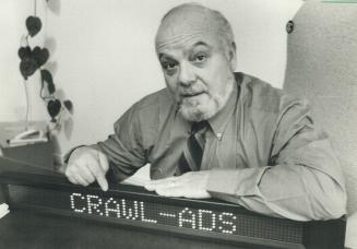 Mobile advertising: Harold Gold, who acts as national sales co-ordinator for Crawl-Ads, shows a model of the message screen that would be installed in the front Passenger seat of cabs