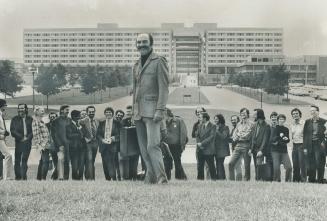 Jules Heller, dean of York University's faculty of fine arts, stands with his staff in front of the Behavioral Sciences Building.