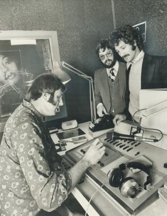 The Media Group, three young men who plan to pipe live radio programming into a chain of stores across Canada, are Tim Deterling, seated, Perry Goldberg and Tony Zwing