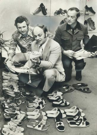 Their Jobs Eliminated by Ottawa's quotas on shoe imports, Frank Van Beek (left), Ray Haines (right) and a third employee of Shoe Import Co