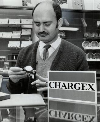 Saul Goldkind has a Chargex card in his jewelry and gift store on Danforth Ave