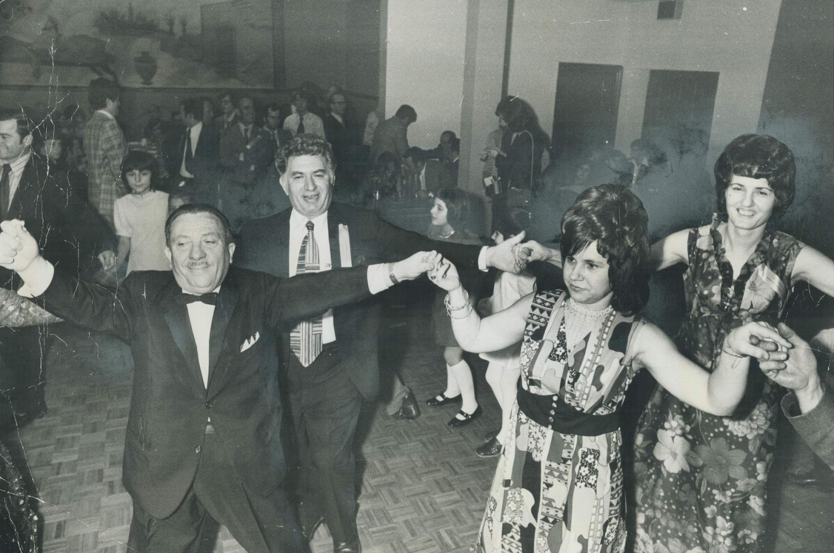 Demetrios Hatzis has a ball as he leads dancers of all ages in the Kalamatianos, a Greek folk dance, at a banquet in his honor sponsored by the Greek-Canadian Roumeli Association on Saturday night