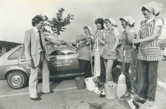 Don Hay gives Mini Maids an inspection before the start of a day's work