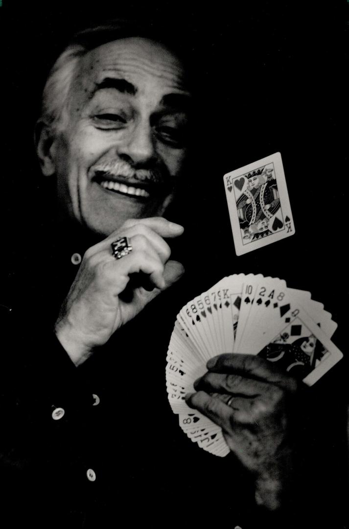 Famous trick: Magician Henry Gordon, 70, demonstrates the famous rising card trick.