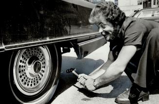 John Goodman tests his product by pounding nail into his tire. It worked