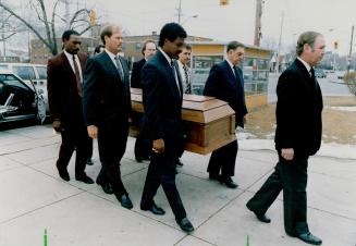 Farewell to a friend: Blue Jays Lloyd Moseby, Ernie Whitt and George Bell (this side of casket, left to right) returned to Toronto from their spring training camp in Florida for the funeral of Norm Hinsley yesterday