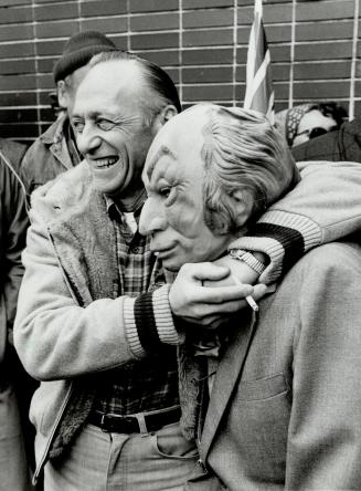 Gassing it up: Jack Halpert, left, a gas station owner who is defying Ottawa by selling gas by the gallon, puts a headlock on Ken Long, sporting a Pierre Trudeau mask