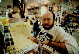 Sour note: North York record store owner Marty Herzog, who was charged for being open yesterday, already has a sheaf of summonses for the same offence