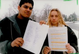 Fighting back: Zul Hirji and fellow student Alexandra Klimczuk hold petition protesting demands that seven at George S