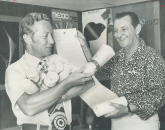 Bundles of support: Gordon Hutchinson (left), deputy commissioner of parks and recreation for North York, holds bundles of signatures from borough residents while Michael Nagy, chairman of the North York Olympic Committee, holds one of the bundles open to show some of signatures on a letter