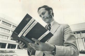 John Hogarth, a professor at Osgoode Hall law school, looks over his report on the methods and attitudes of lower court judges in sentencing offenders