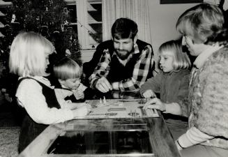 Happy on base: Lt.-Cmdr. Brent Hobson, his wife, Dawn, and their children, Leah, 9, Jill, 6, and Cole, 3, enjoy a game at their home. Dawn Hobson says they are happier on the base than off.