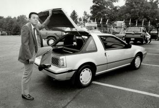 Stepping into future: Nissan Canada president Roy Hoshino leans on the company's new Pulsar model with a removable rear deck, which will sell for a minimum of $13,887