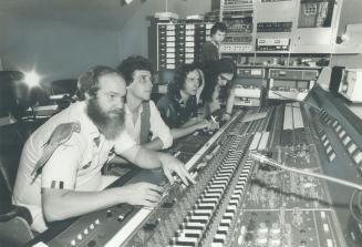 Music mix: Syd Kessler, bird perched on his shoulder, controls the board during a recording session in the studio at his Kessler Vollum Productions