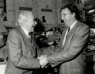 East meets west: Viadimir Luzyanin, left, general director of Hydromash, a Soviet gear maker, shakes hands with Alex Hogg, vice-president and general manager of Menasco Aerospace Ltd
